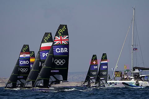 Boats start a men's skiff race